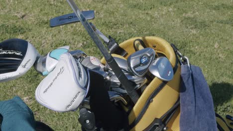 overhead close up shot, high def, hand selecting golf club, pulling out of golf bag