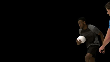 serious rugby players tackling for ball