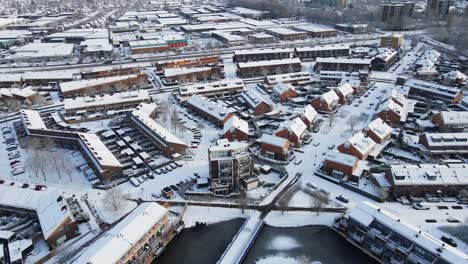 cinematic aerial of a beautiful suburban neighborhood covered in snow on a sunny day