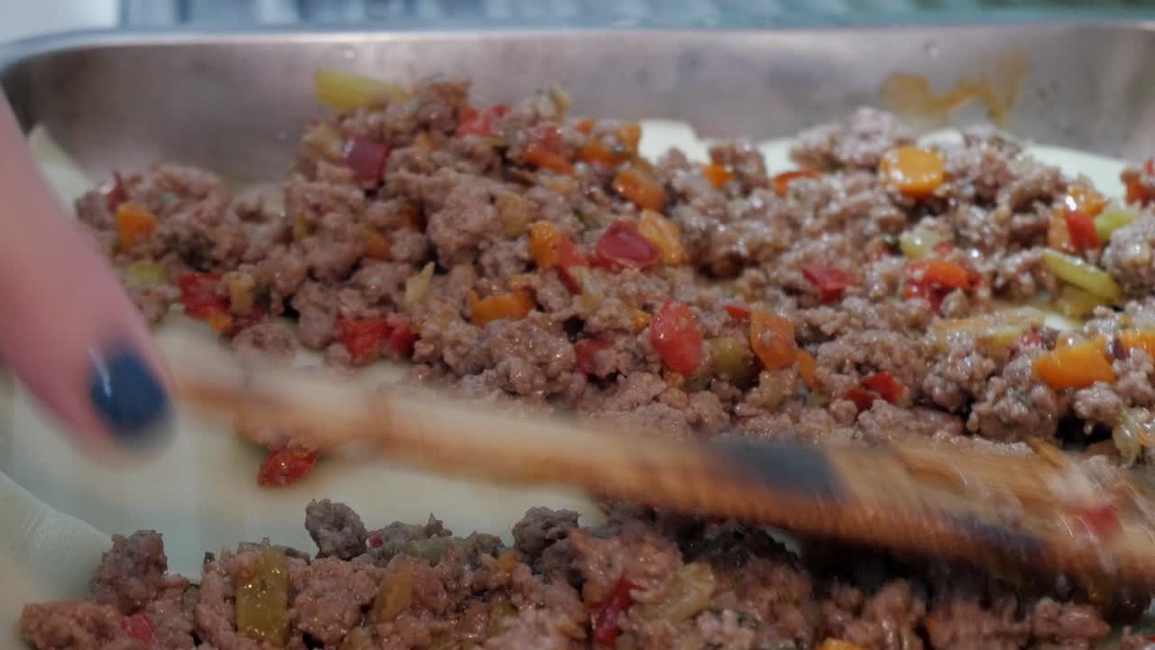 Minced meat with peppers on lasagna sheet for cooking in the kitchen