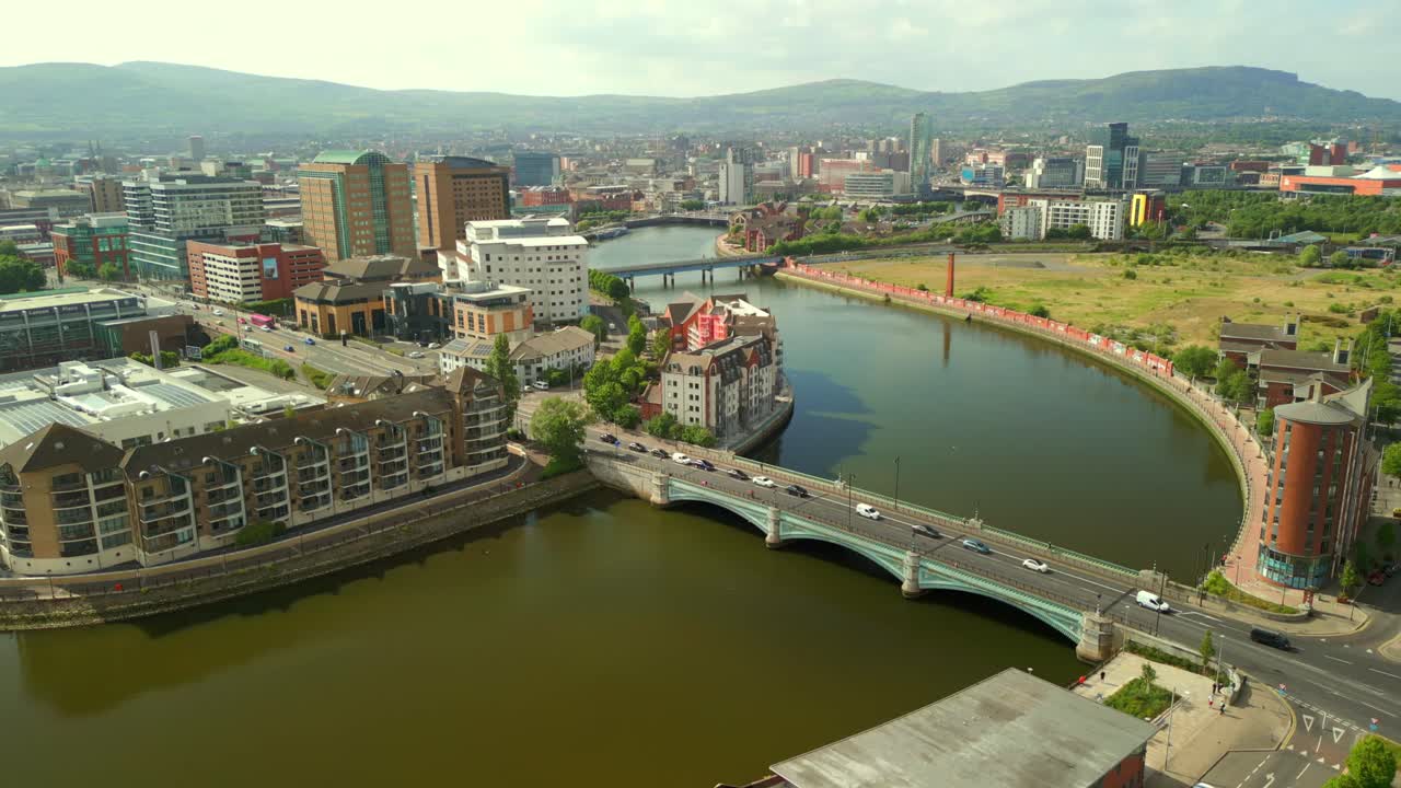 Side-on advancing aerial video of Queen's Bridge, the passing traffic and the River Liffey in Belfast, Northern Ireland in the UK. Produced in 4K, 60 frames per second and with Rec709 color.