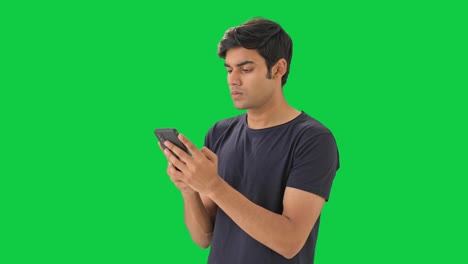 Indian-boy-chatting-with-someone-Green-screen
