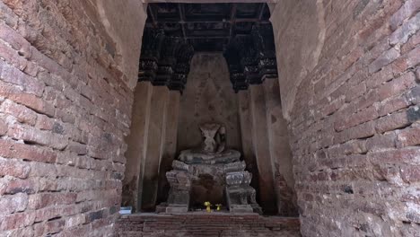 slow reveal of a buddha statue inside a temple