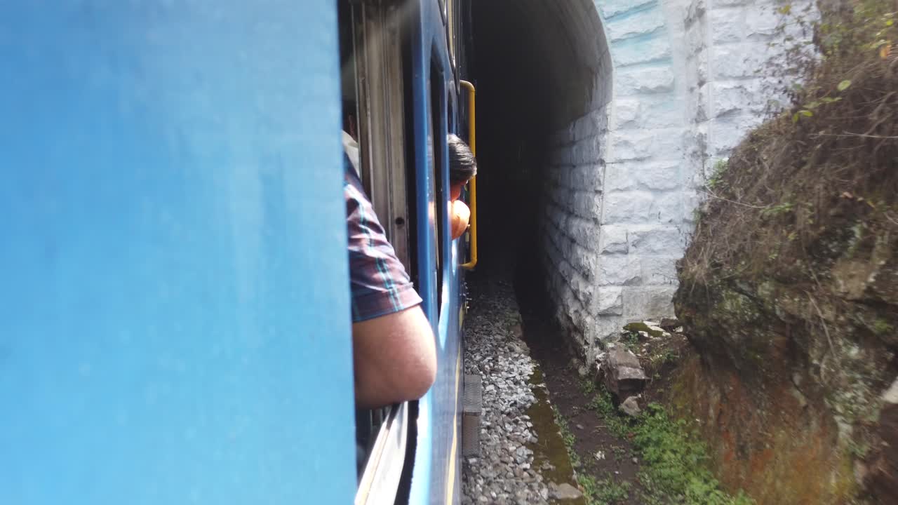 Tourists Look from the Windows of The Nilgiri Mountain Railway Train As It Enters A Tunnel at Ooty, Udagamandalam, Ootacamund, Udhagai, Tamil Nadu, India.