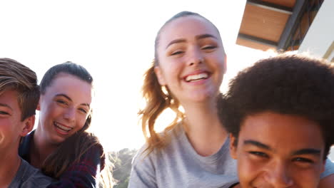 Portrait-Of-High-School-Students-Giving-Each-Other-Piggybacks-College-Buildings