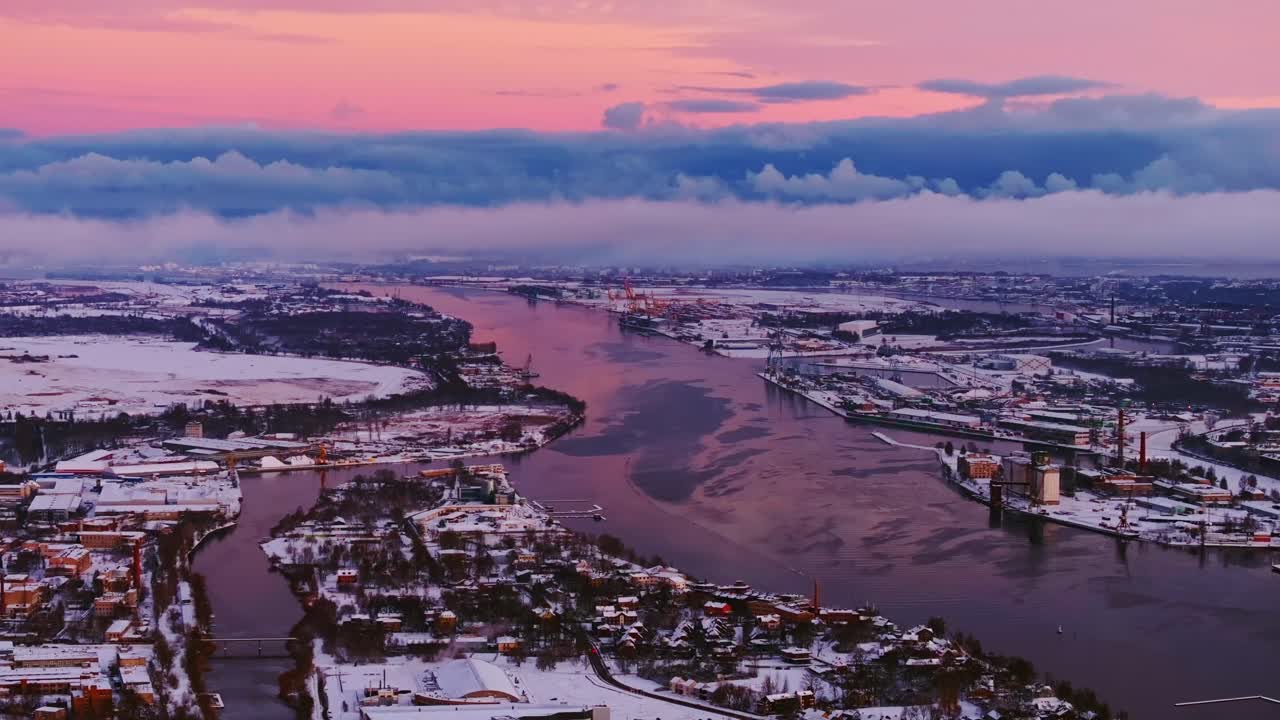 Riga bathed in the soft glow of a winter sunrise, blue cloud, pink sky, drone