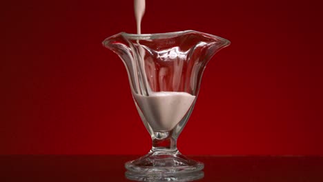 pouring yogurt smoothie into a glass