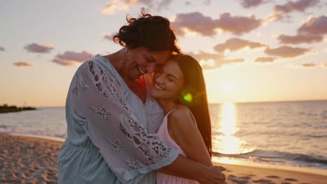 joyful moments: mother and daughter on the beach at sunset