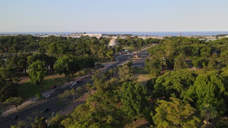 dolly in flying over palermo woods near the galileo galilei planetarium with rio de la plata river in background, buenos aires, argentina