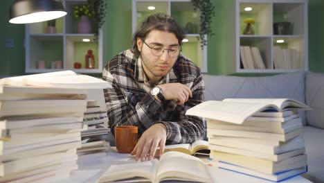 Thoughtful-young-student-reading-a-book,-studying.