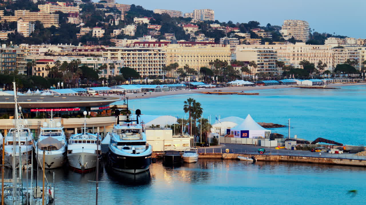 Cannes, France - March 15, 2025: View of multiple boats docked in the Cannes Marina with the buildings of the city on the background at sunset