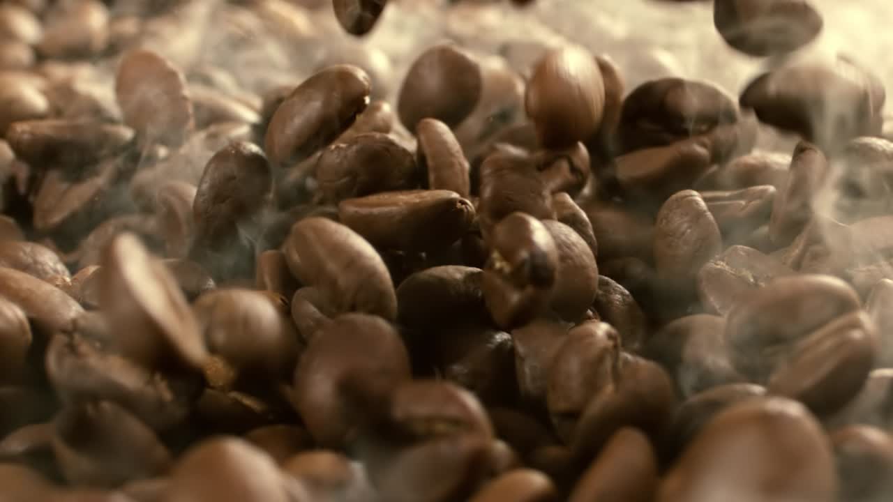 Coffee beans are falling close-up