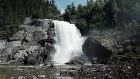 stunning landscape of chute neigette waterfall cascading into the river with lush coniferous trees in rimouski, quebec, canada