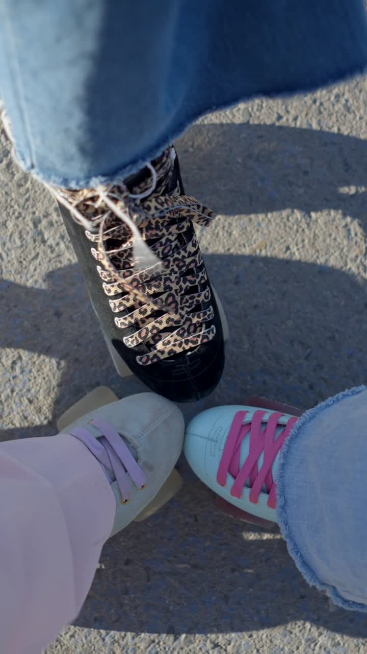 Three Pairs of Roller Skates on Concrete