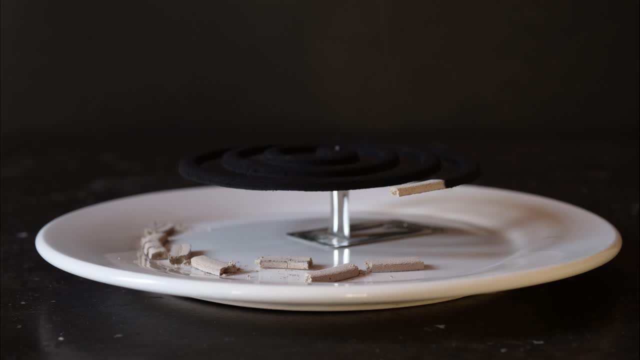Mosquito coil repellent on a holder and plate burning time lapse