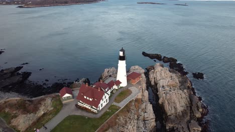 Cinematic-aerial-of-Portland-Head-Lighthouse-in-Cape-Elizabeth-during-winter-in-Maine