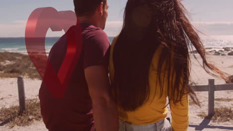 sitting on beach, couple enjoying romantic moment with heart animation overlay