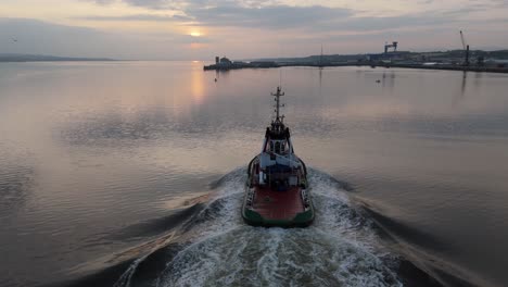 aerial view of a boat going to dock during a sunset in the north sea scotland