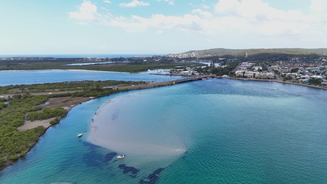 Wide aerial panorama of Swansea waterways and bridge connecting town and surrounding wetlands