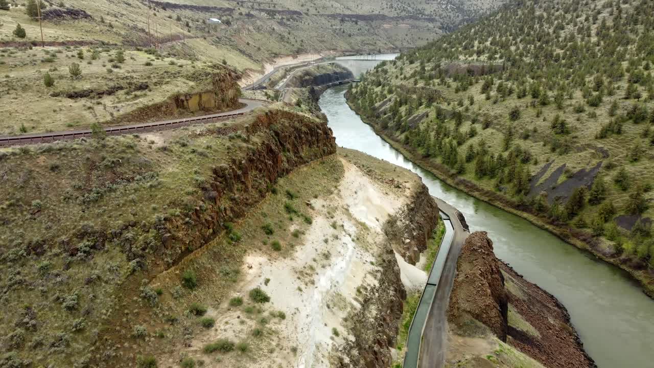 US, Oregon, Warm Springs, Deschutes River, 2025-04-08 - Drone view of the Deschutes River at Pelton Dam in central Oregon, with a long fish ladder below. In spring