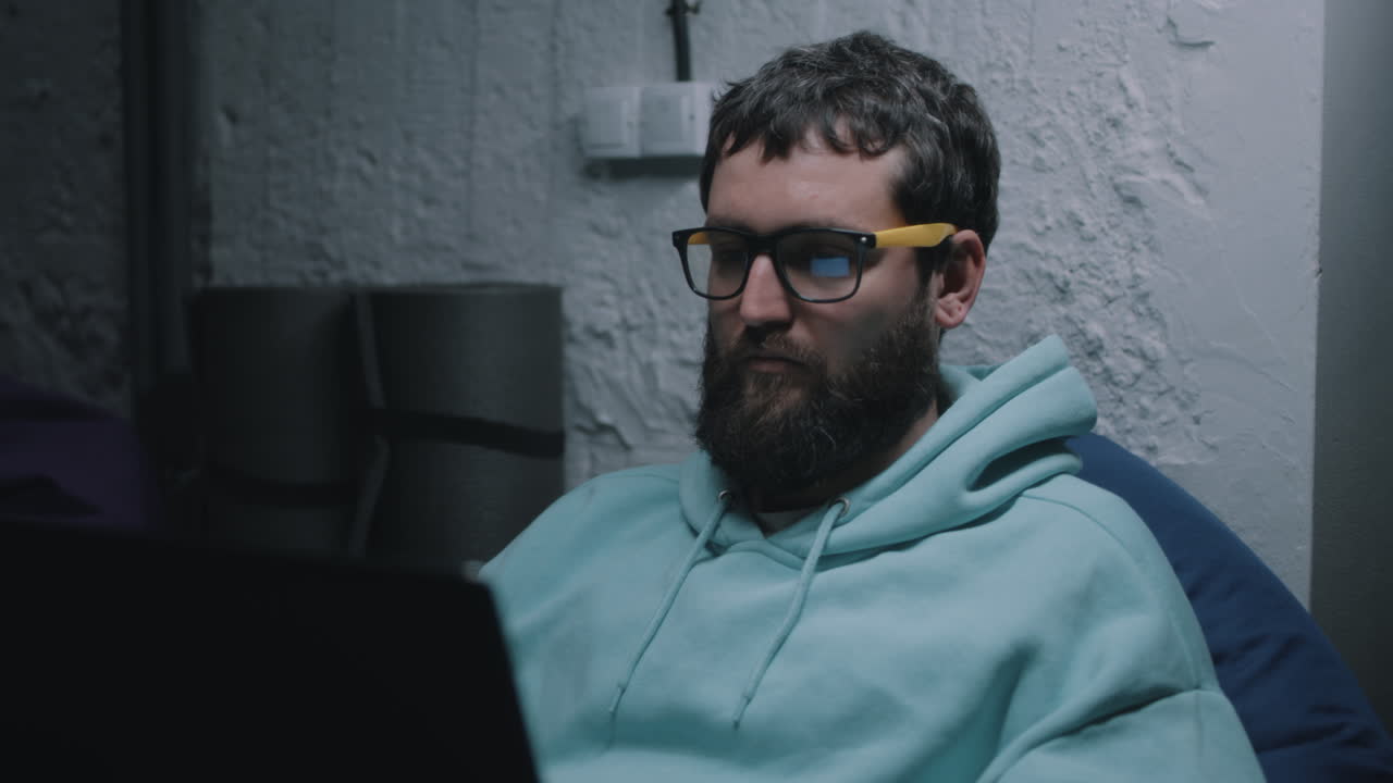 Man Working on Laptop at Night