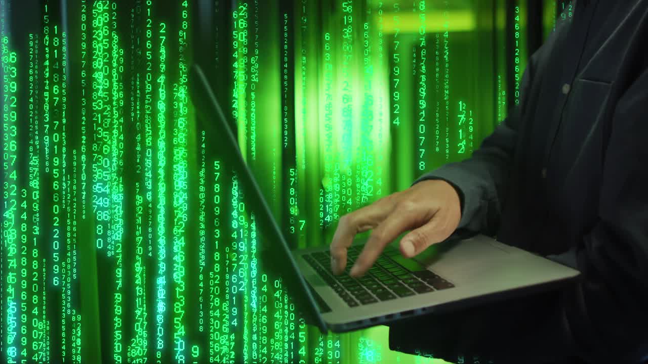 Animation of binary coding over caucasian male worker using laptop in server room