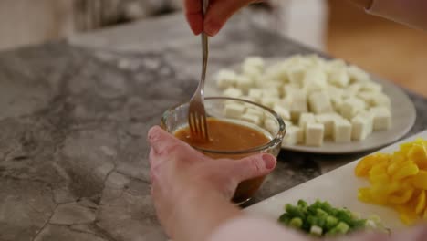 woman stirring sauce for meal in slow motion