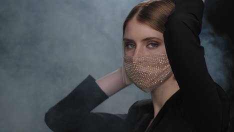 beautiful woman in sequin face mask posing sensually