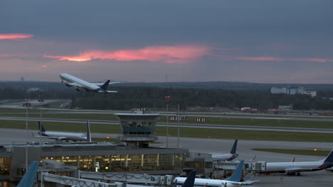 Airplane-evening-departure-airport-view-with-terminal