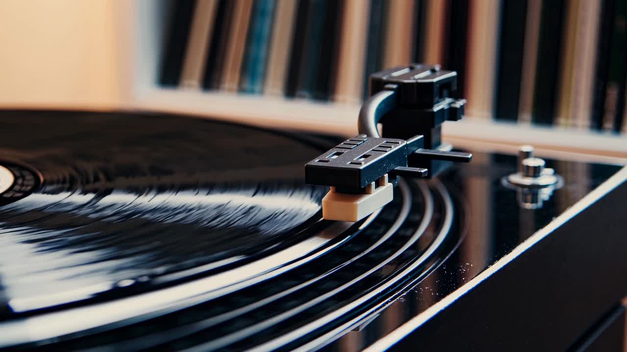 Close-up, angled shot of a vinyl record spinning on a turntable, capturing a retro vibe
