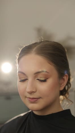 close-up portrait of a woman with golden glitter eye makeup