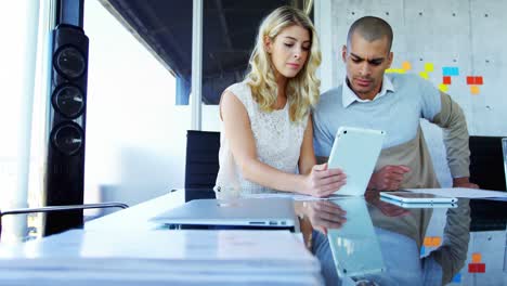 Colleagues-using-digital-tablet-at-table-4k