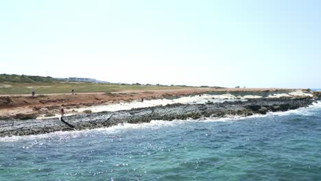 Drone-flying-on-sea-along-rocky-and-jagged-coast-of-Cyprus-island