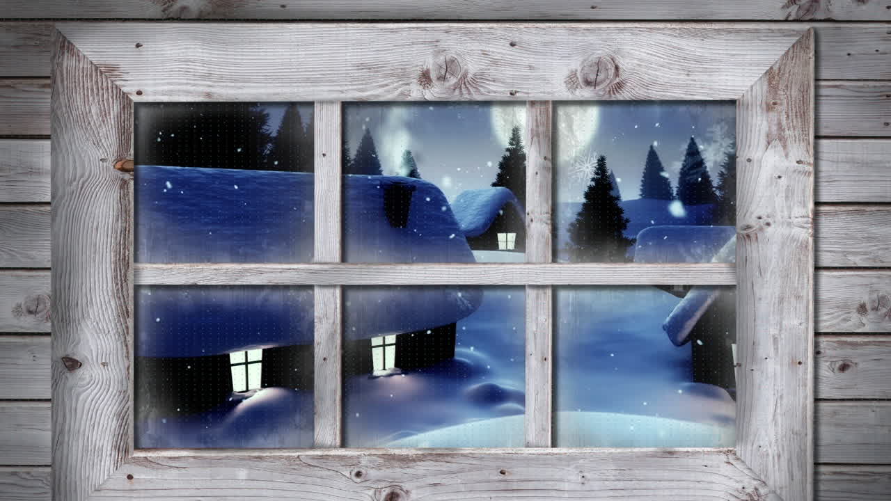 Wooden window frame against snow falling over multiple houses and trees on winter landscape
