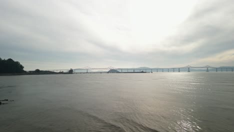 sweeping drone footage captures the richmond–san rafael bridge and point molate beach’s coastline.