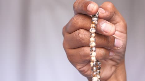 young man hand praying at ramadan, close up