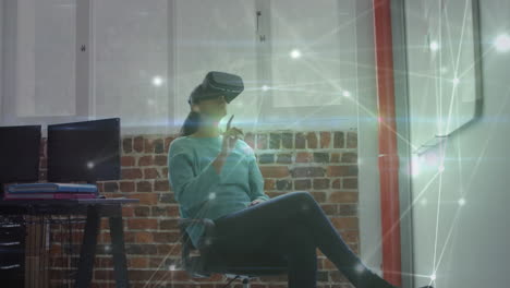 animation of network of connections over businesswoman using vr headset in office