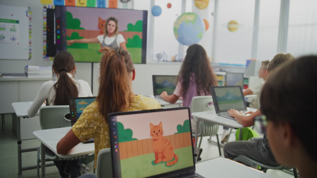 Teacher Educating Young Students During Digital Art Class Showing Creative Learning on Digital