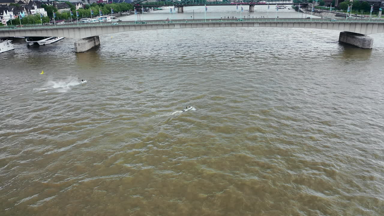 Aerial shot of drone flying above jet ski on Rhine river in Cologne