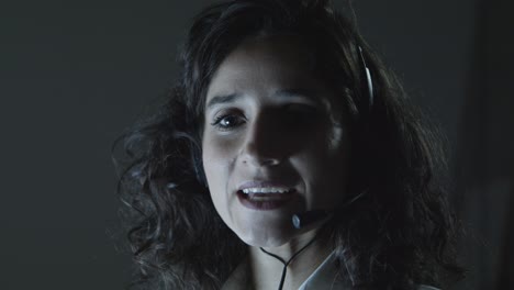 woman in headset talking at camera