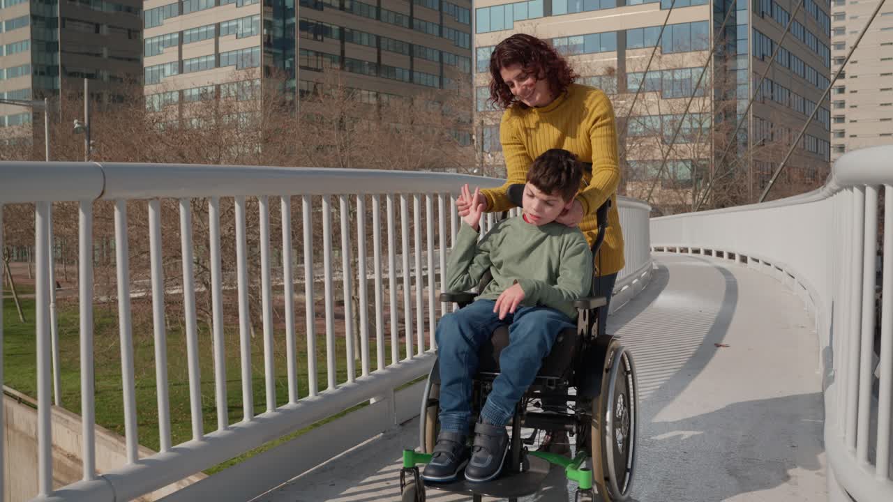 Woman pushing child in wheelchair on bridge