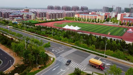 aerial cinematic view of traffic at a quiet intersection in sunny nanhai new district, china