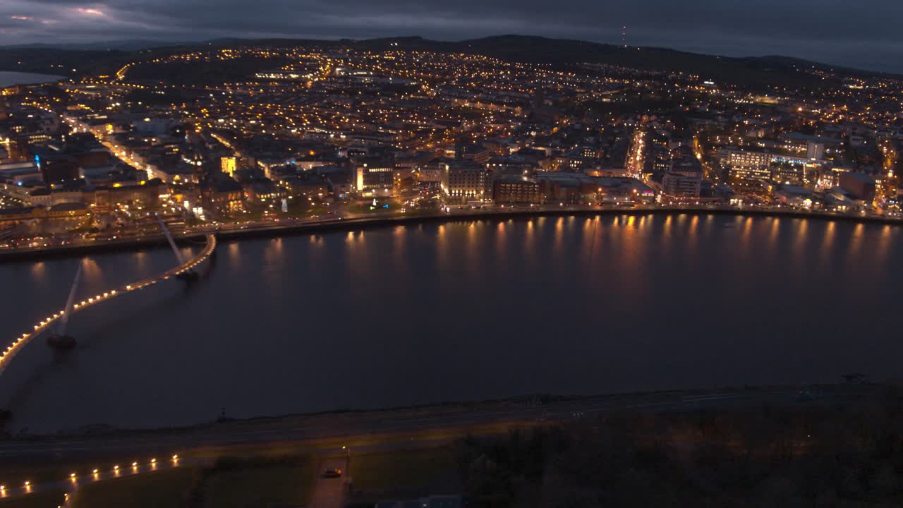 Aerial Night View of a City with a Bridge and River