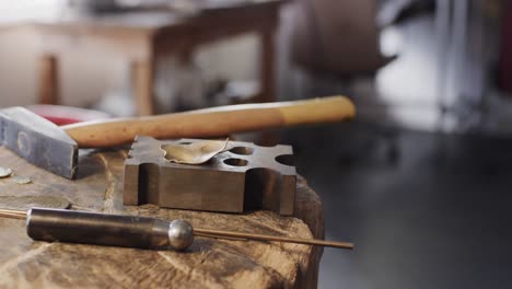 close up of handcraft tools lying on tree trunk in studio in slow motion