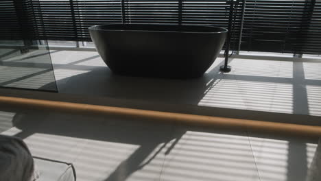 modern black bathtub bathroom with window and blinds