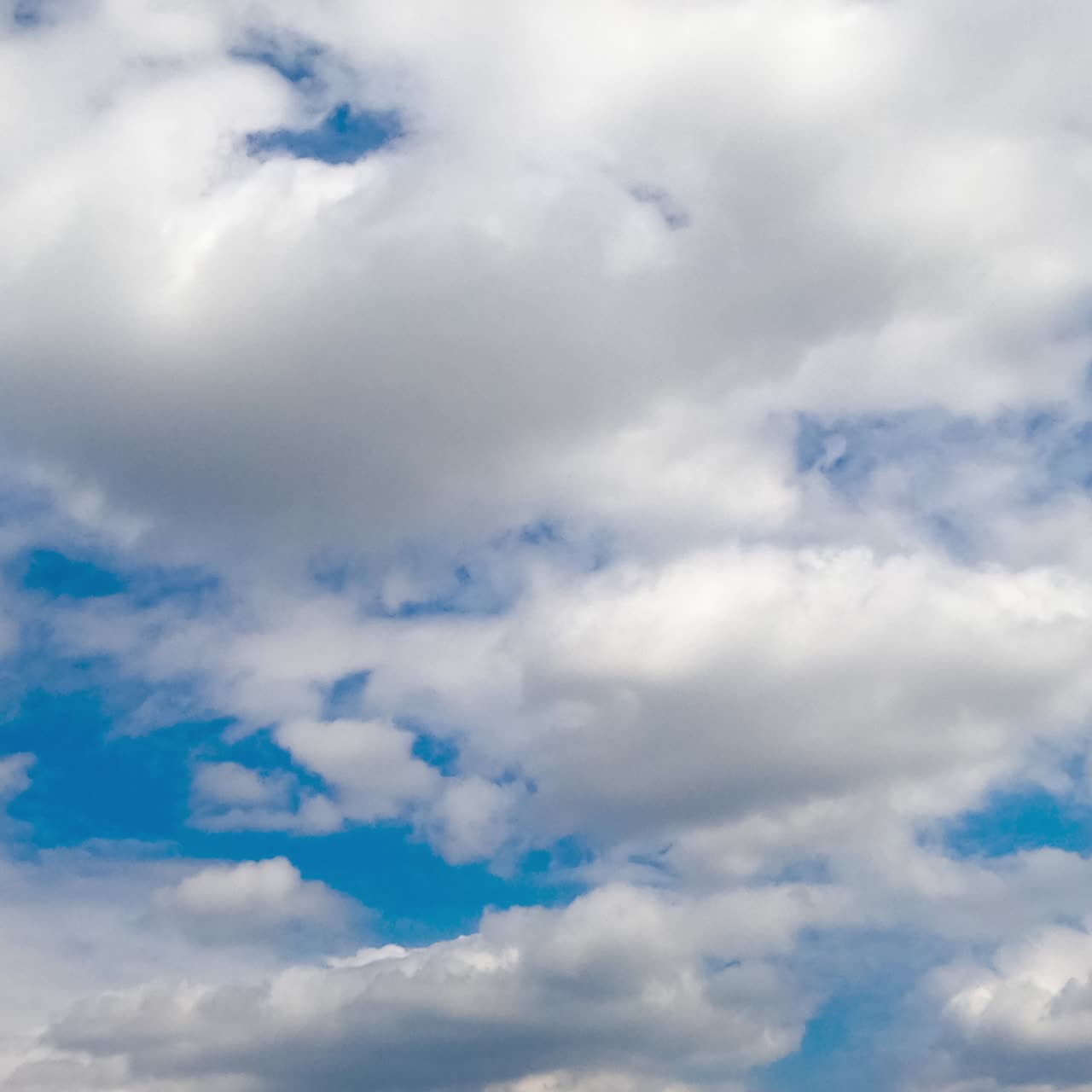 Beautiful white cloudscape formation in the azure sky. Clouds changing shape quickly in the atmosphere. Low angle view. Timelapse