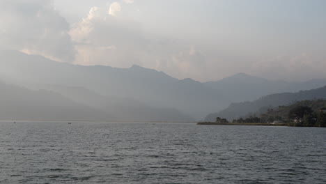 a panning view of fewa lake in pokhara, nepal in the late evening light