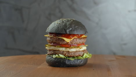 turkey black burger with mushrooms and mushroom sauce on black stone tray