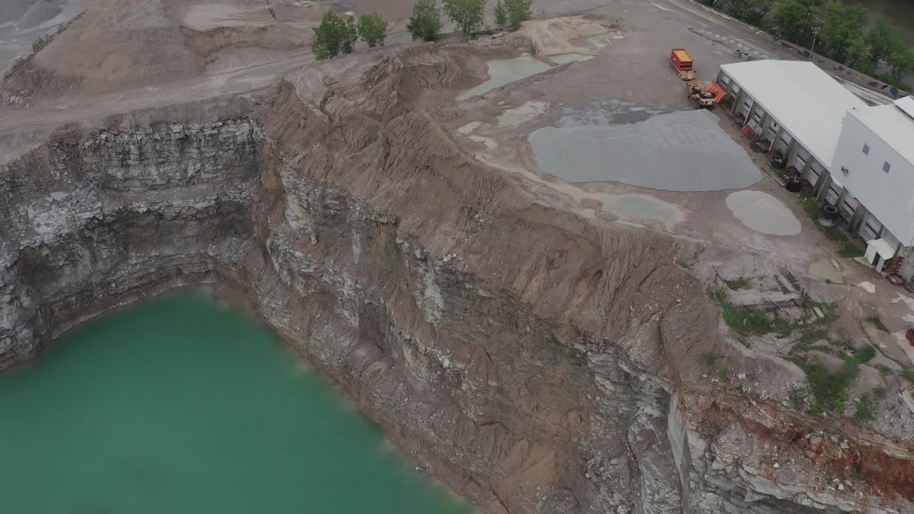 drone vuela sobre una cantera en el medio oeste de estados unidos y mira hacia abajo en formaciones de tierra fría