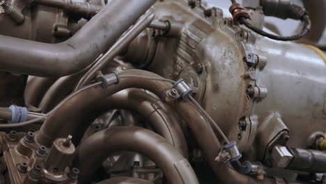 Airplane-engine-being-worked-on-by-mechanics-close-up